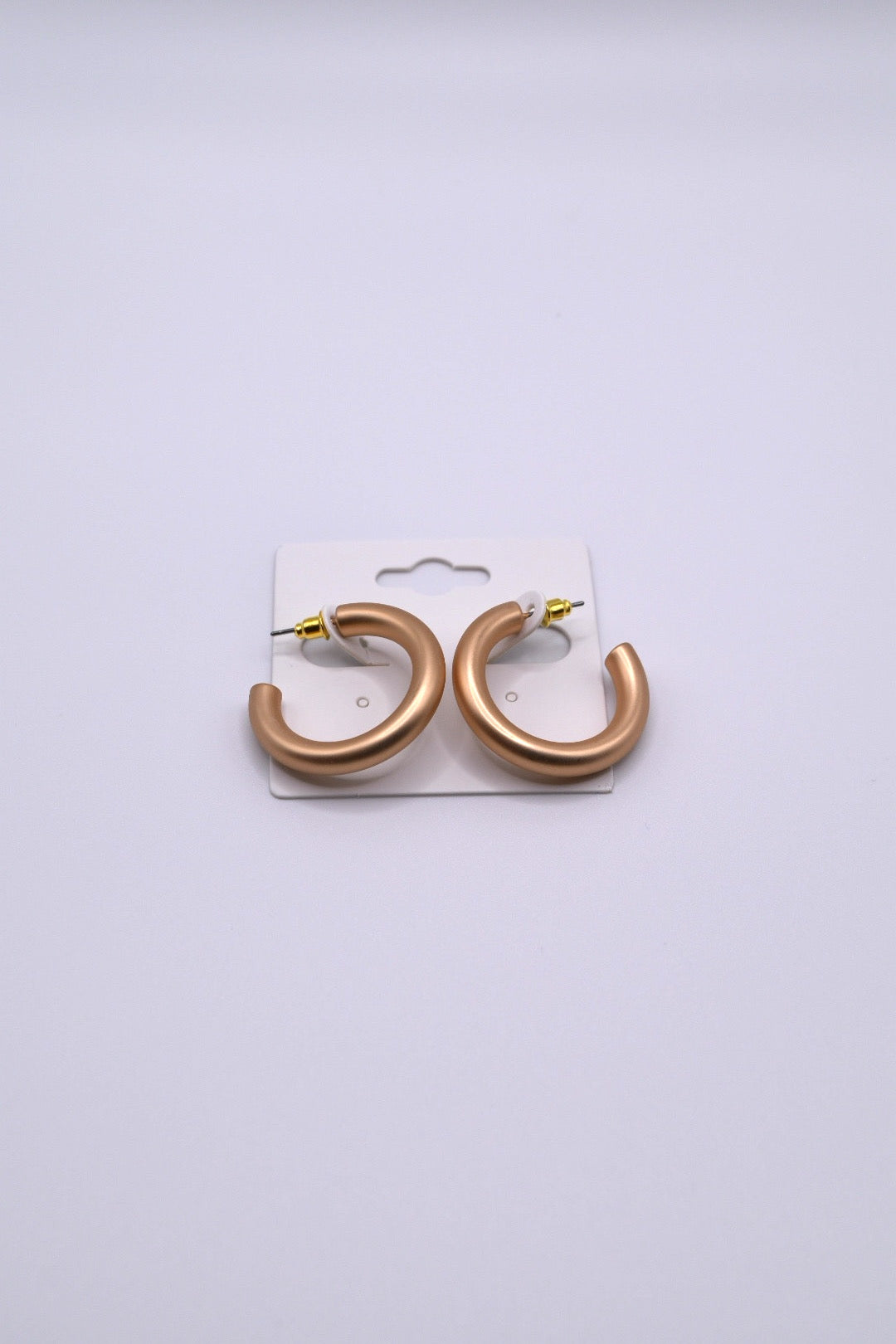 Matte gold hoops measuring 1in in diameter.