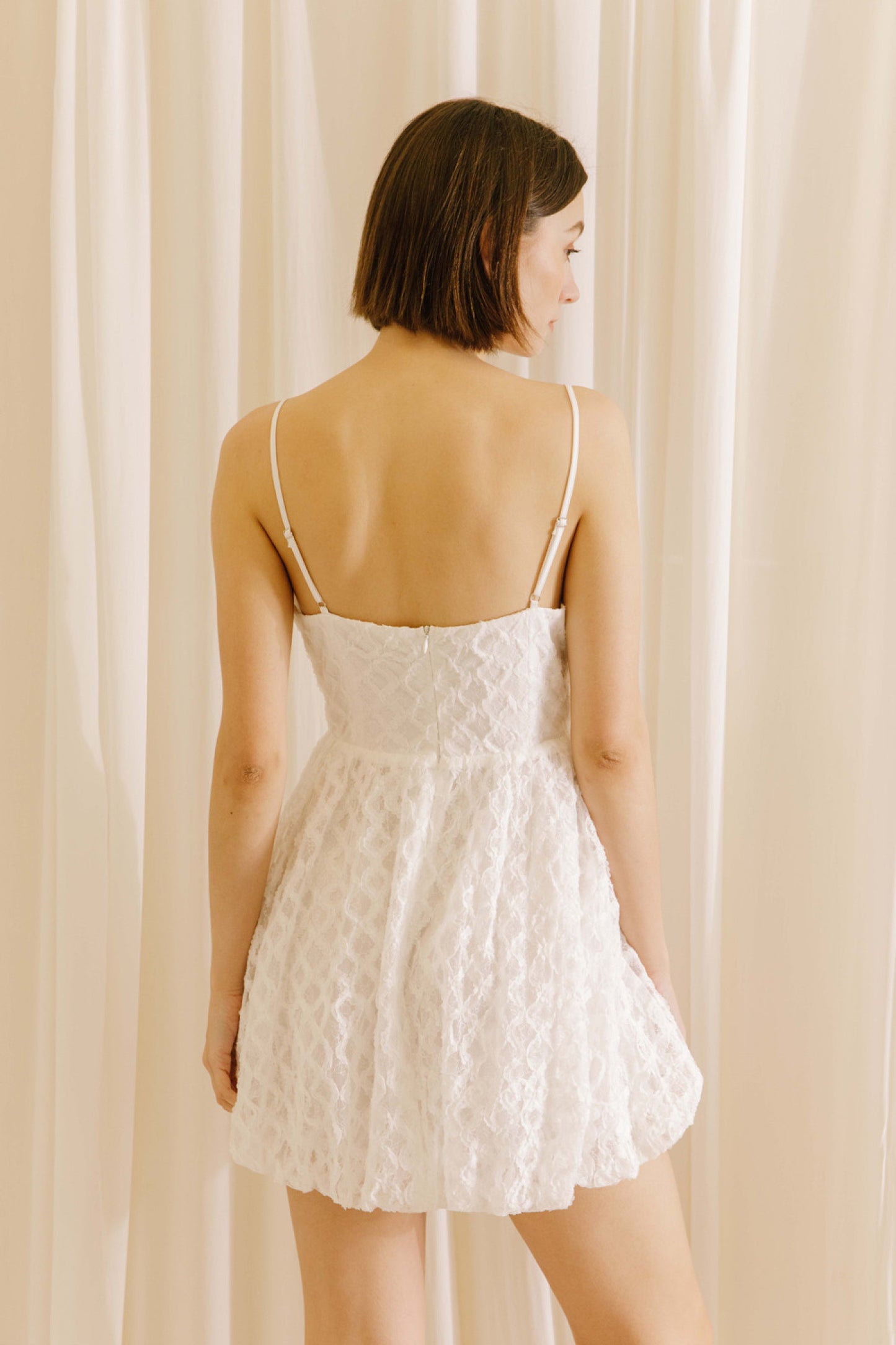 "Betty" Lace Mini Dress - White. Back view.