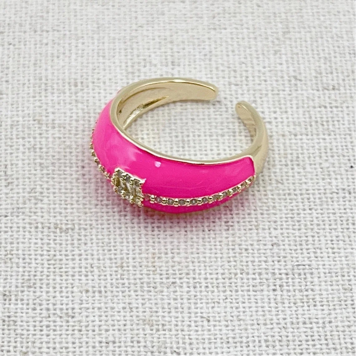 Pink with gold and crystal detailing. Adjustable.