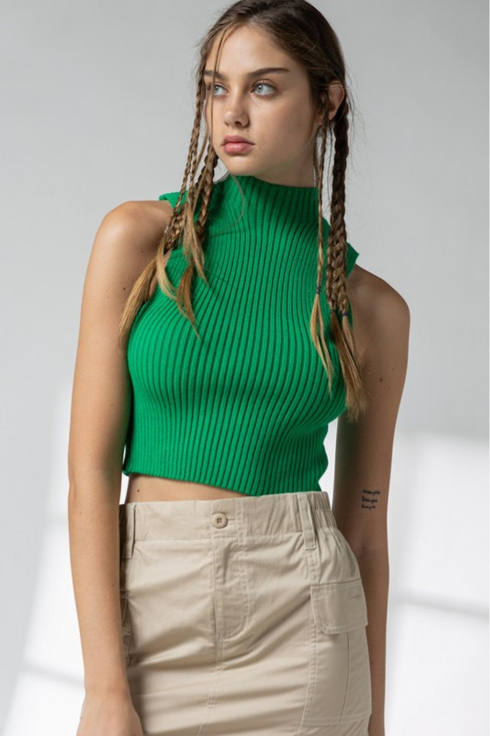 Mock neck ribbed sleeveless sweater in green.  Front view.