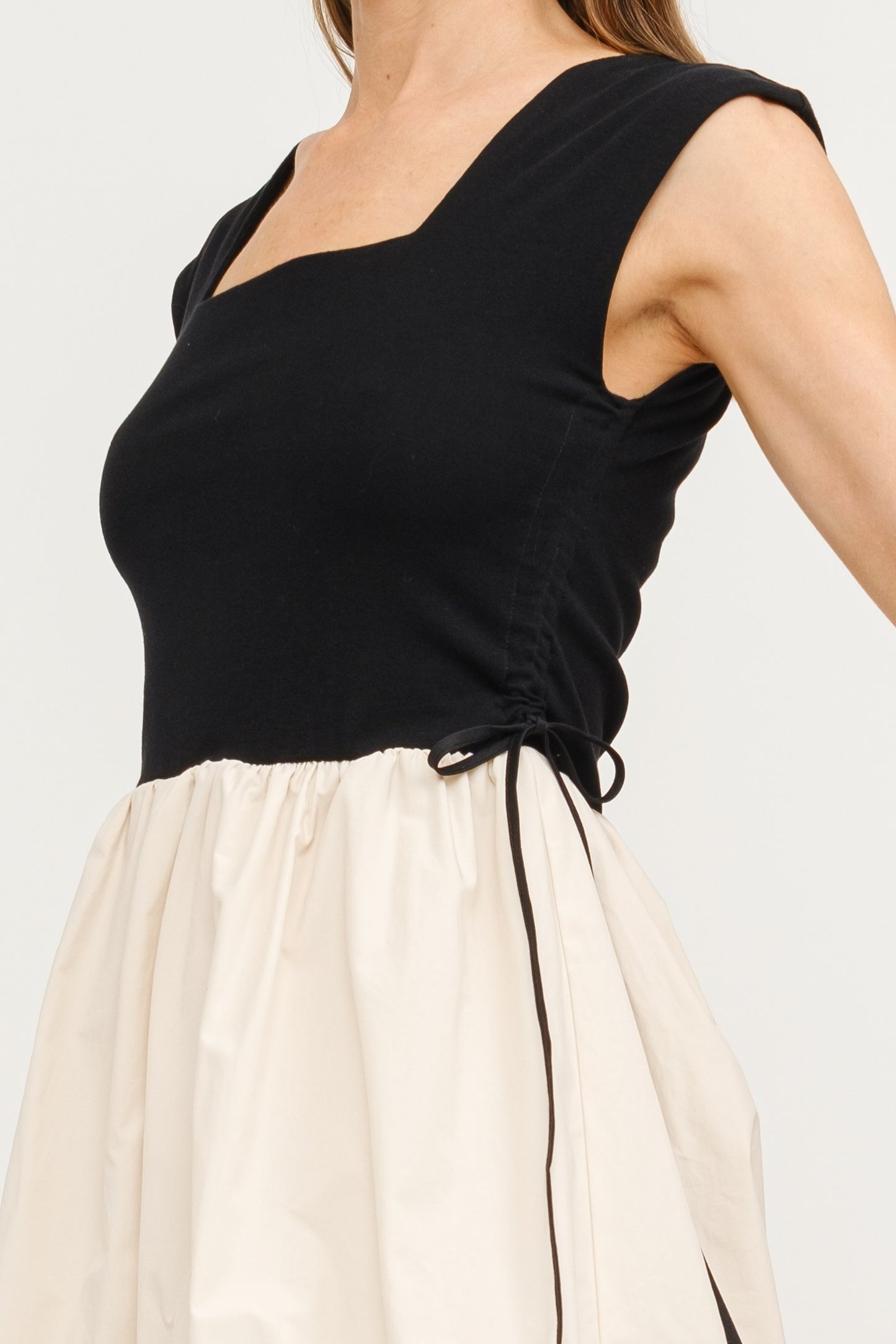 Combination Bubble Hem Dress - Black & Natural.  Side tie view.