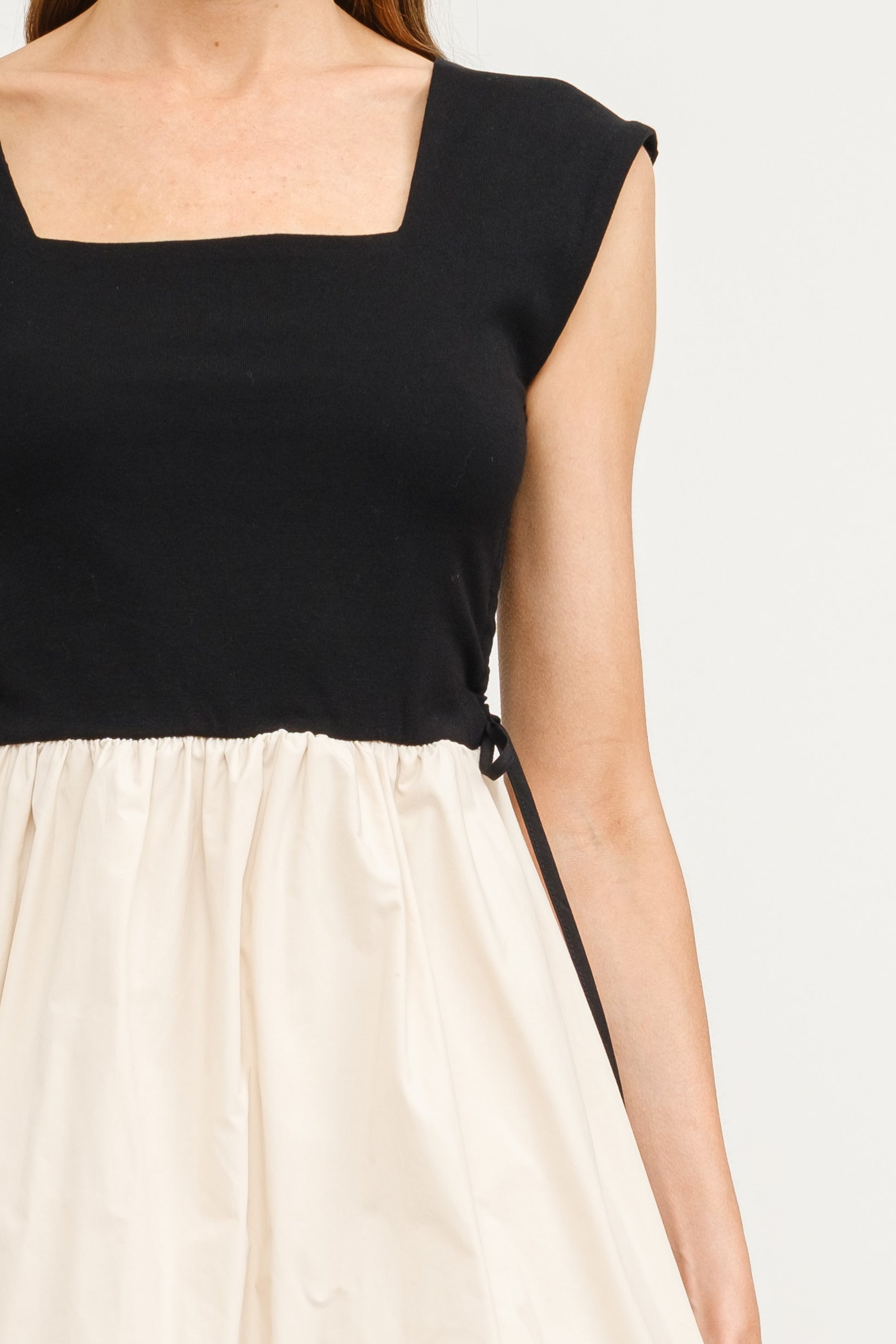 Combination Bubble Hem Dress - Black & Natural.  Front tie view.