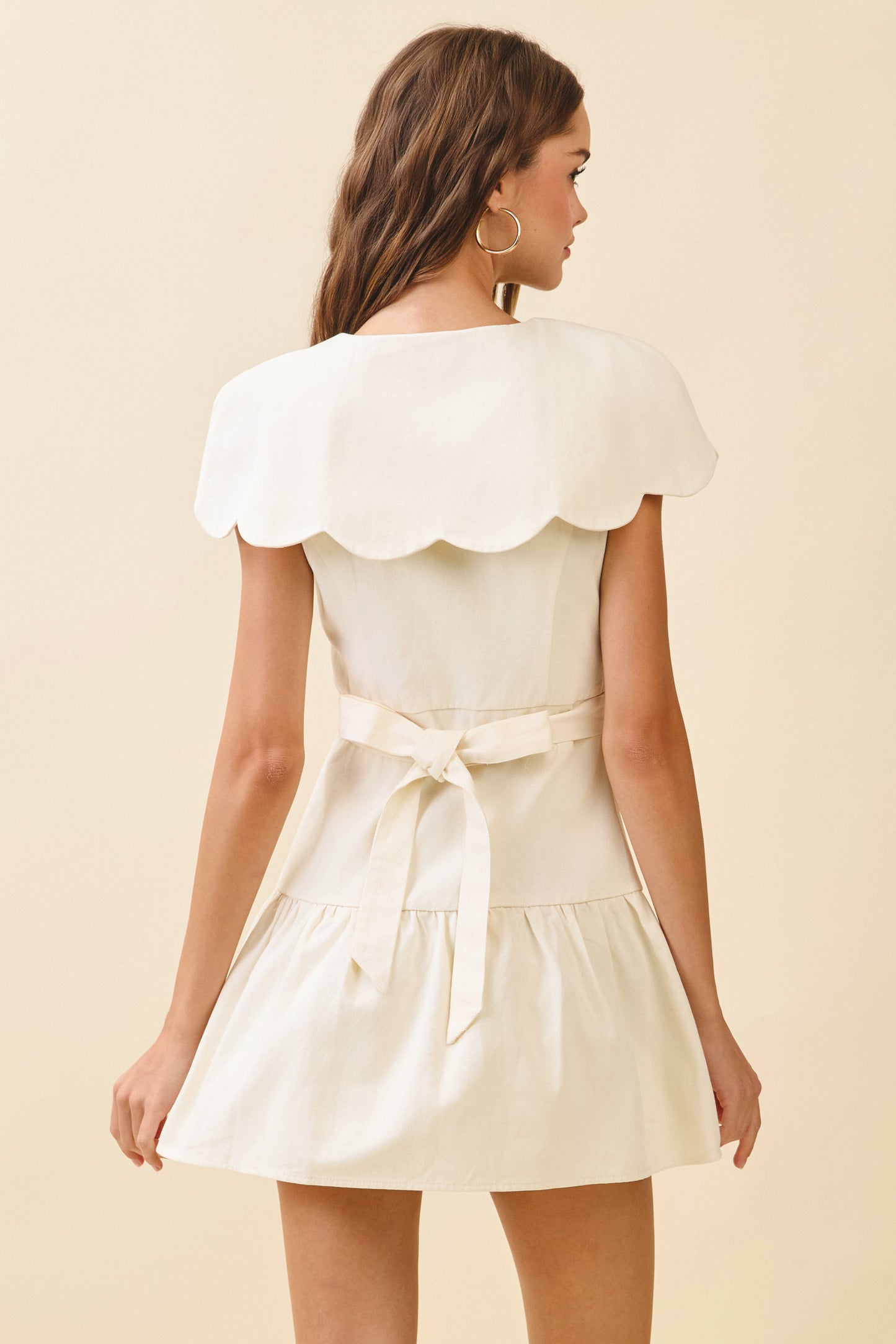 Woven mini dress with Scalloped collar, front buttons, and tie back - Back close view.