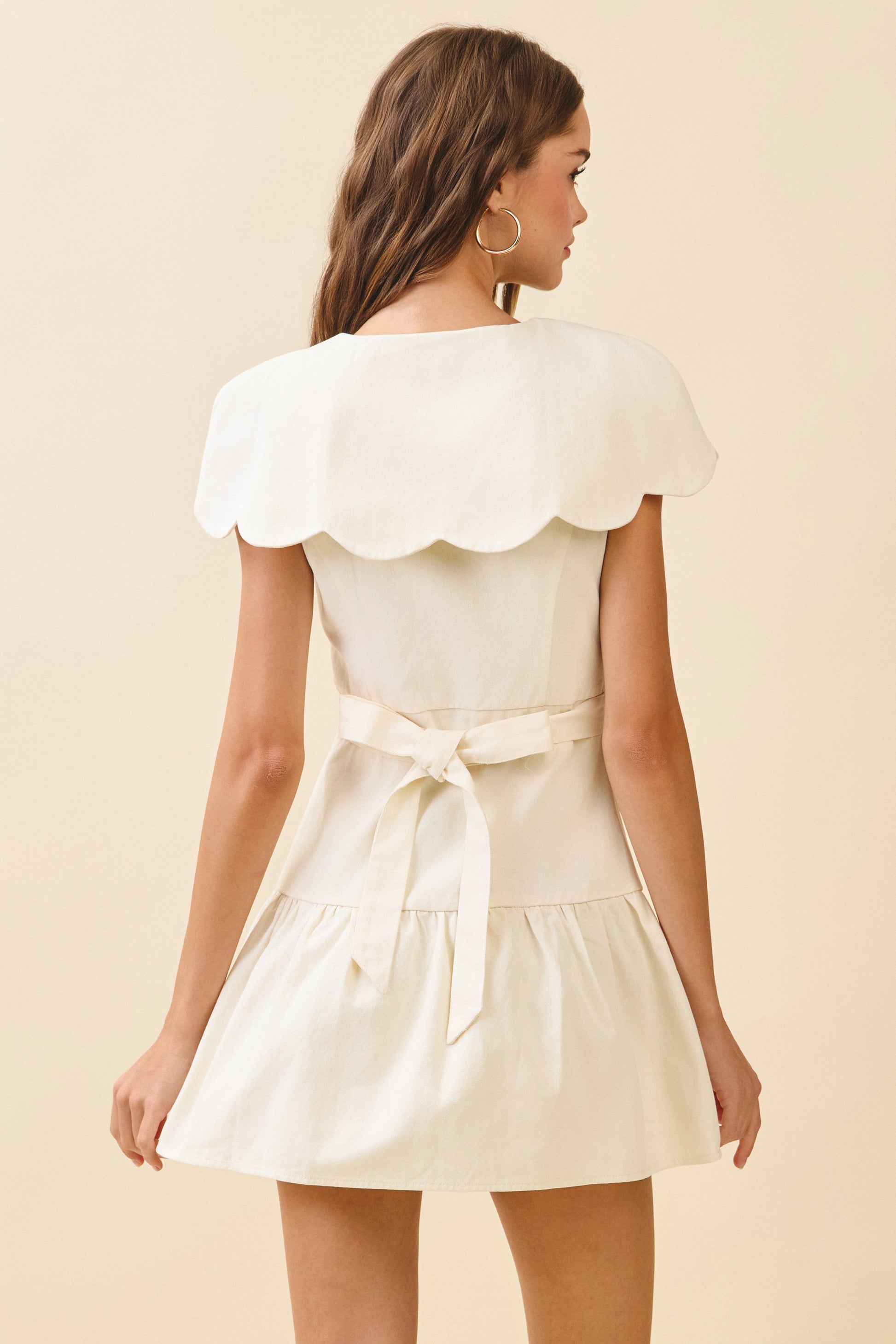 Woven mini dress with Scalloped collar, front buttons, and tie back - Back close view.