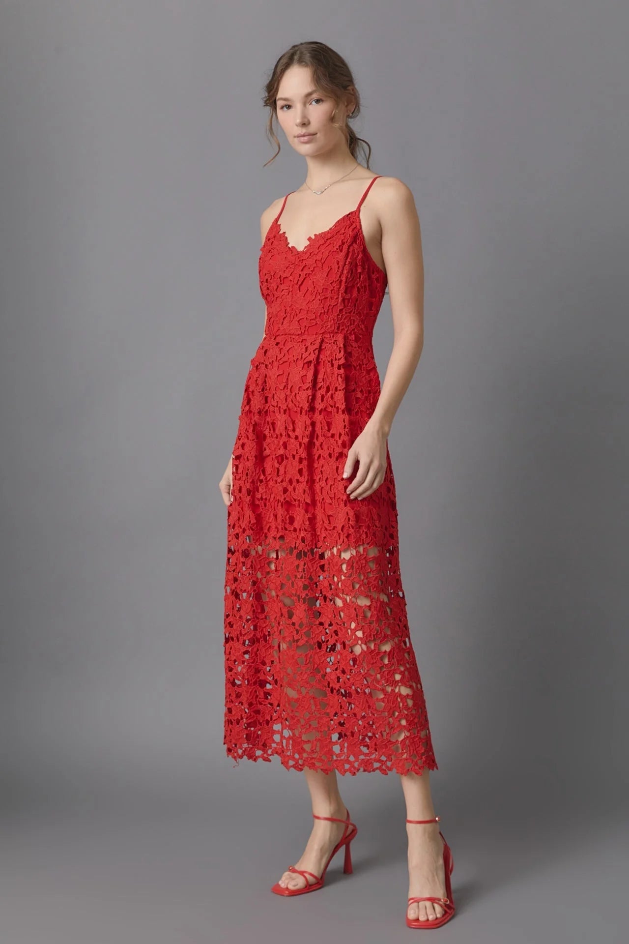 Lace overlay mini dress in red. Side full view.