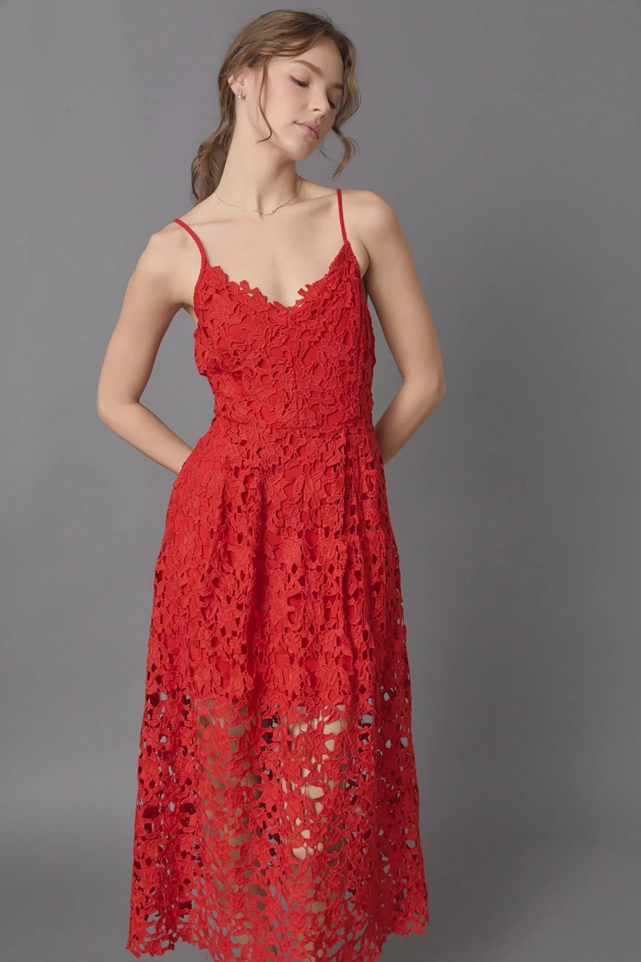 Lace overlay mini dress in red. Front close view.
