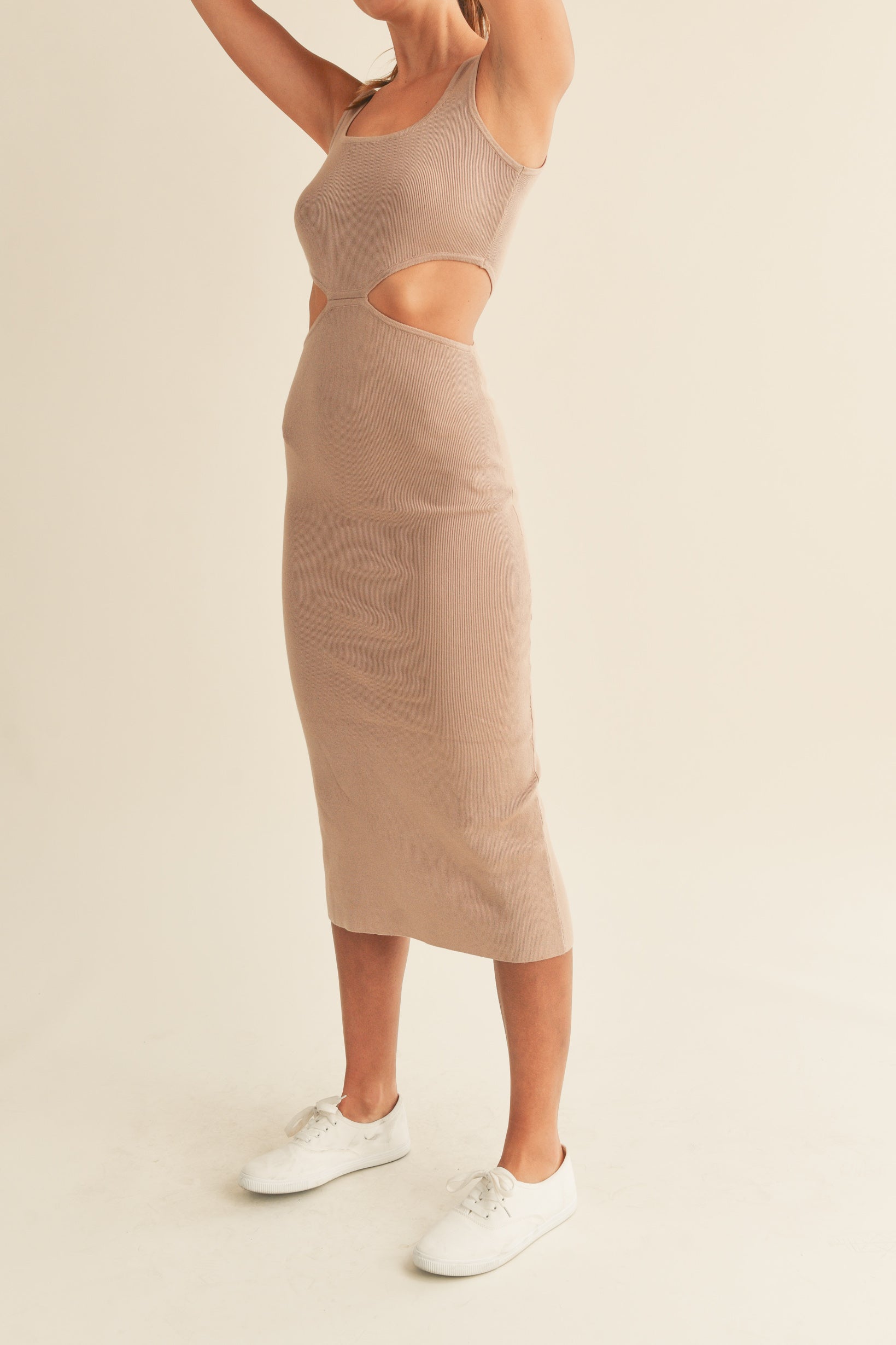 Knit sleeveless midi dress in mocha features side cut outs and a tank-style top.   Side view.