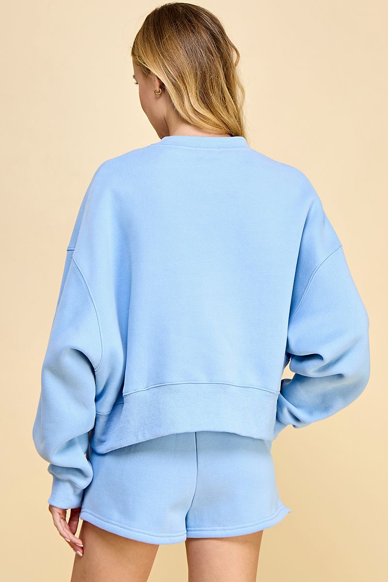 Matching sweat shirt & shorts set in Baby Blue.  Back view.