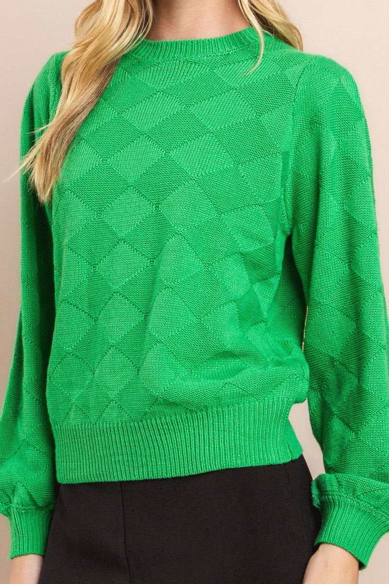 Oversized diamond textured long sleeve knit sweater with balloon sleeves.  Close up front view.