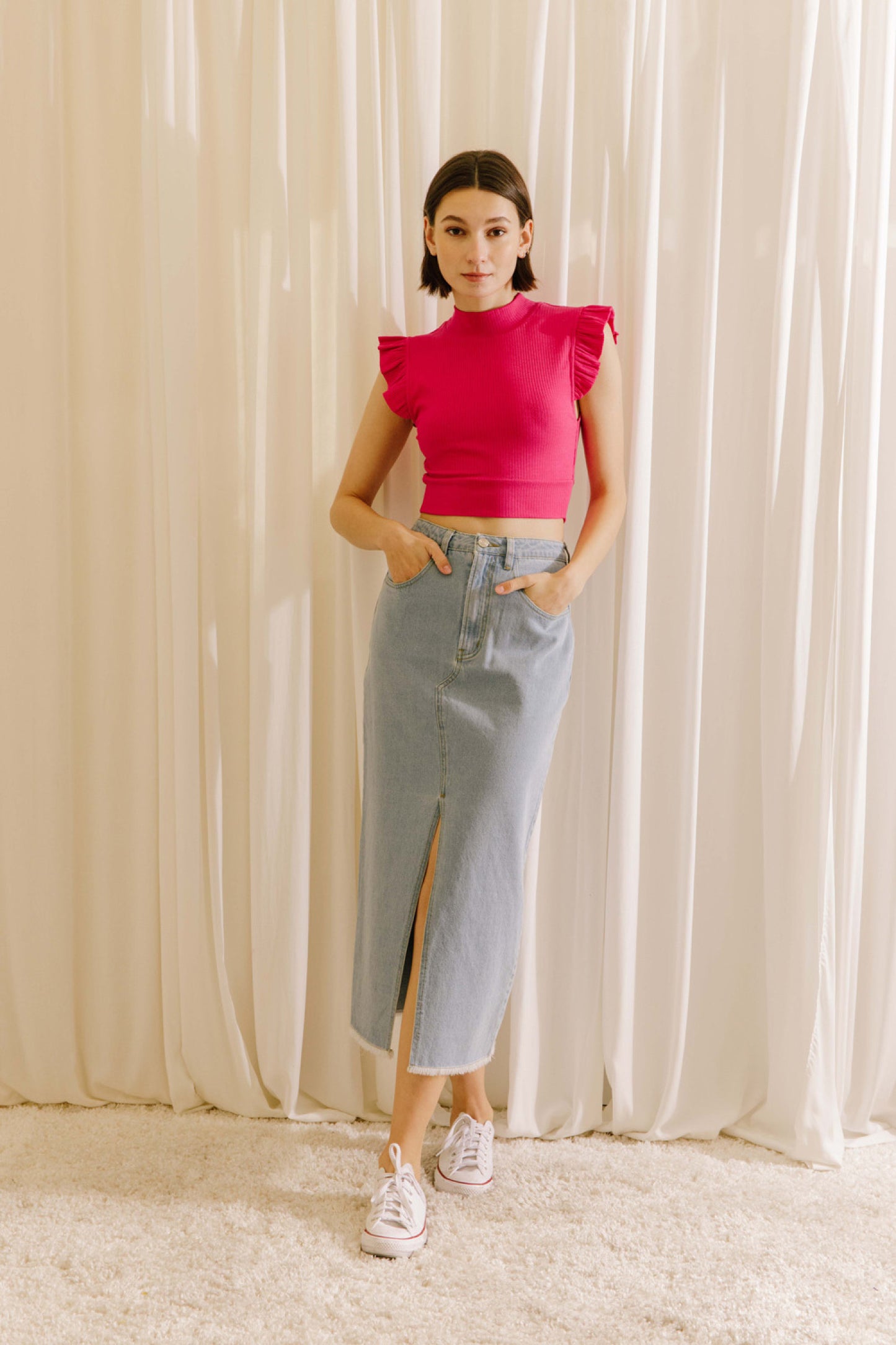 Ribbed knit mock neck crop top in fuchsia featuring ruffle sleeves.  Full view.