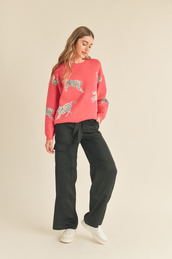 Leopard knit sweater in pink.  Black & white mohair leopard. Ribbed crewneck. Drop shoulder long sleeves. Relaxed fit pullover.  Full view.