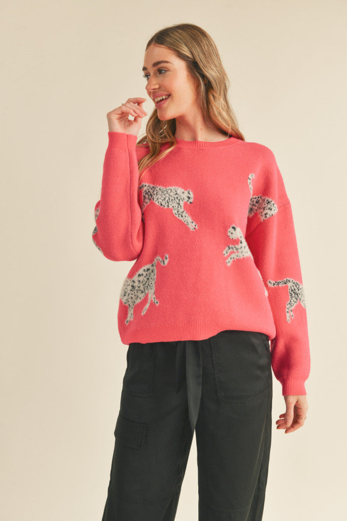 Leopard knit sweater in pink.  Black & white mohair leopard. Ribbed crewneck. Drop shoulder long sleeves. Relaxed fit pullover.  Full view.