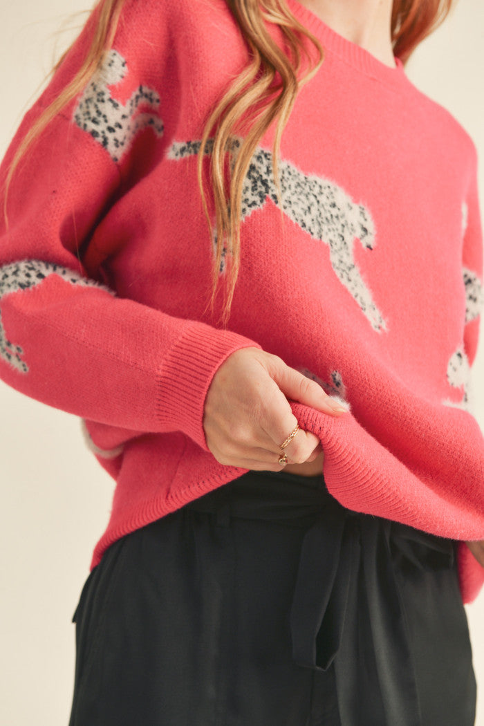 Leopard knit sweater in pink.  Black & white mohair leopard. Ribbed crewneck. Drop shoulder long sleeves. Relaxed fit pullover.  Close up view.