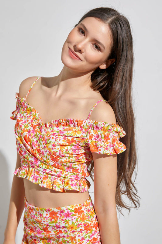 Cami top in pink & orange featuring ruffle off the shoulder sleeves and spaghetti straps and an elastic back.  Front close view.